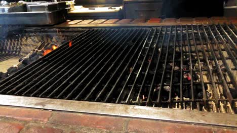 chef preparing charcoal grill for cooking