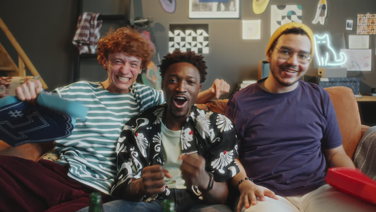 Friends High Fiving and Celebrating when Watching Sports Game on TV at Home