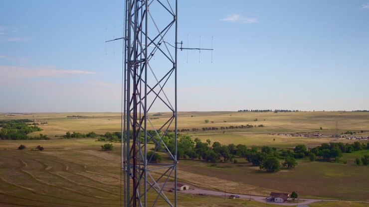 Drone view of a cellular tower with plains in the background