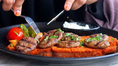 delicious turkish meatballs with white sauce and tomato