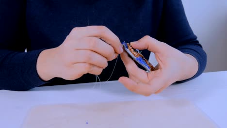 designer making handmade brooch