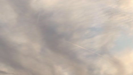 slowly moving airplanes between the clouds in an autumn day