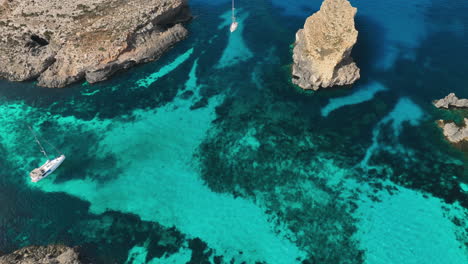 footage from a drone flying over the crystal lagoon on the island of comino in malta