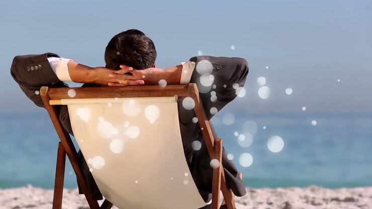caucasian man sitting on deck chair in front of sea with bubble light animation