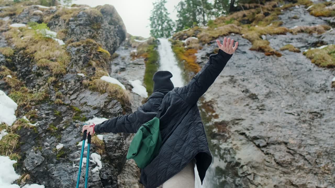Adventurous Hike by a Waterfall in Winter Mountains