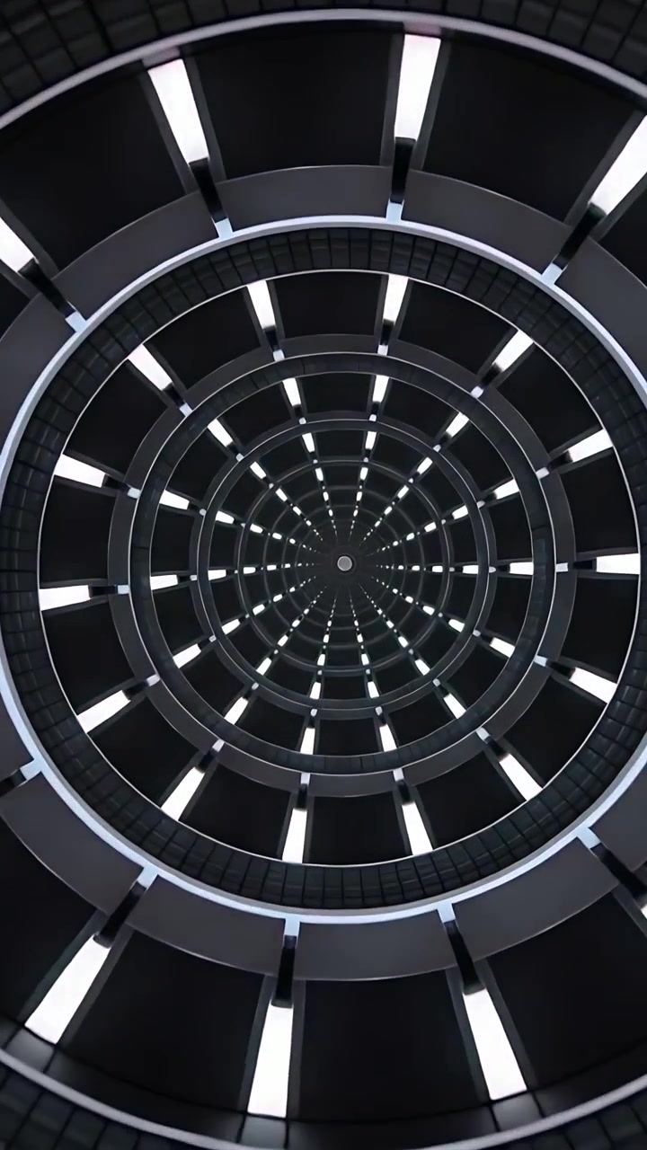 Video verticale: Pannelli LED di un atrio che cambiano colore ciclicamente e la telecamera che si inclina, creando un centro ipnotico.