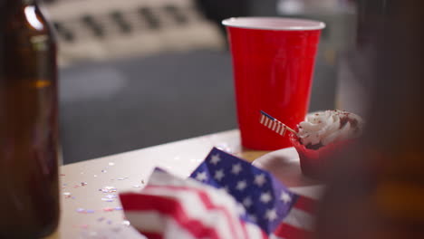 close up of cupcakes american stars and stripes flags and bottles of beer at party celebrating 4th july independence day 5