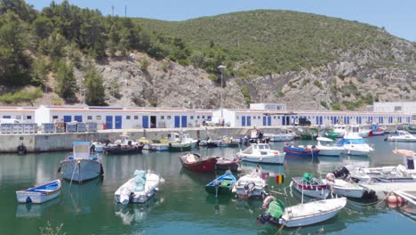 a harbour with lots of mooring fishing boats in a sleepy portuguese town sesimbra