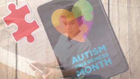 Animation of puzzle and autism awareness month text over caucasian boy smiling