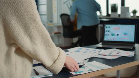 Selective-focus-on-woman-hands-holding-tablet-zooming-in-on-sales-pie-chart-and-comparing-data