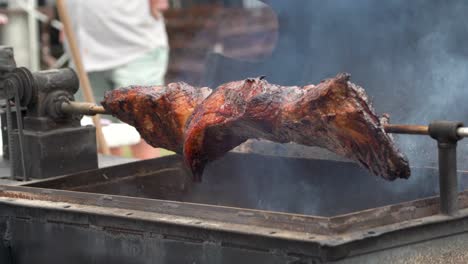 primer plano de carne asada encendiendo un asador en un festival