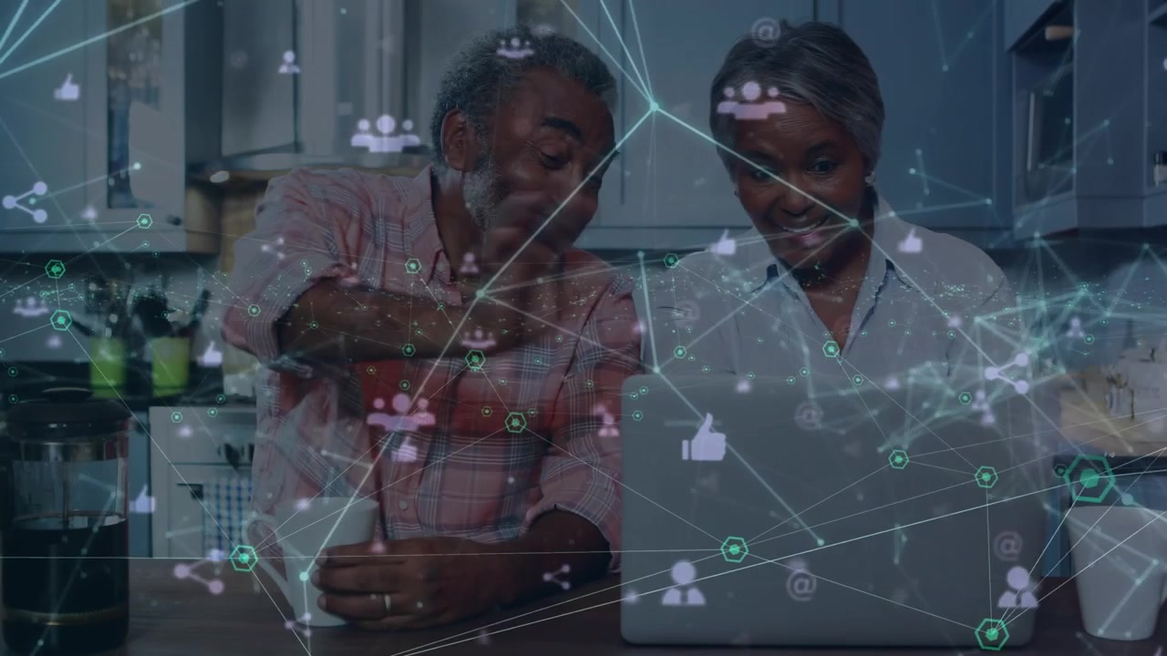 Animation of network of connections over happy senior couple working on laptop at home