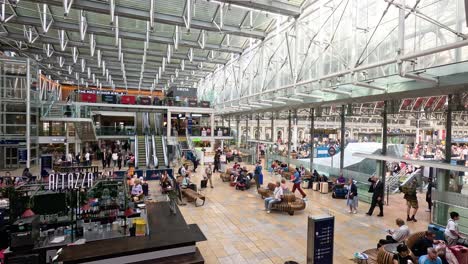 crowds and activity at paddington station, london