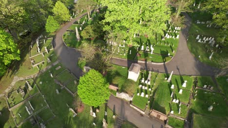 Tombstones-casting-long-shadows-in-beautiful-garden-cemetery