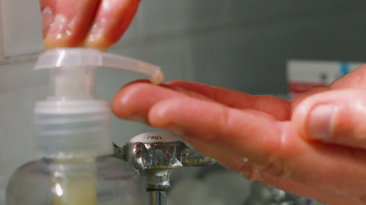 Soap Being Decanted onto Fingers Ready to Clean in Sink with Fresh Hot Water to Remove Germs and Viruses. Healthy Hygiene Clip