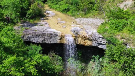 a wide drone shot of pericnik falls in the national park of triglav