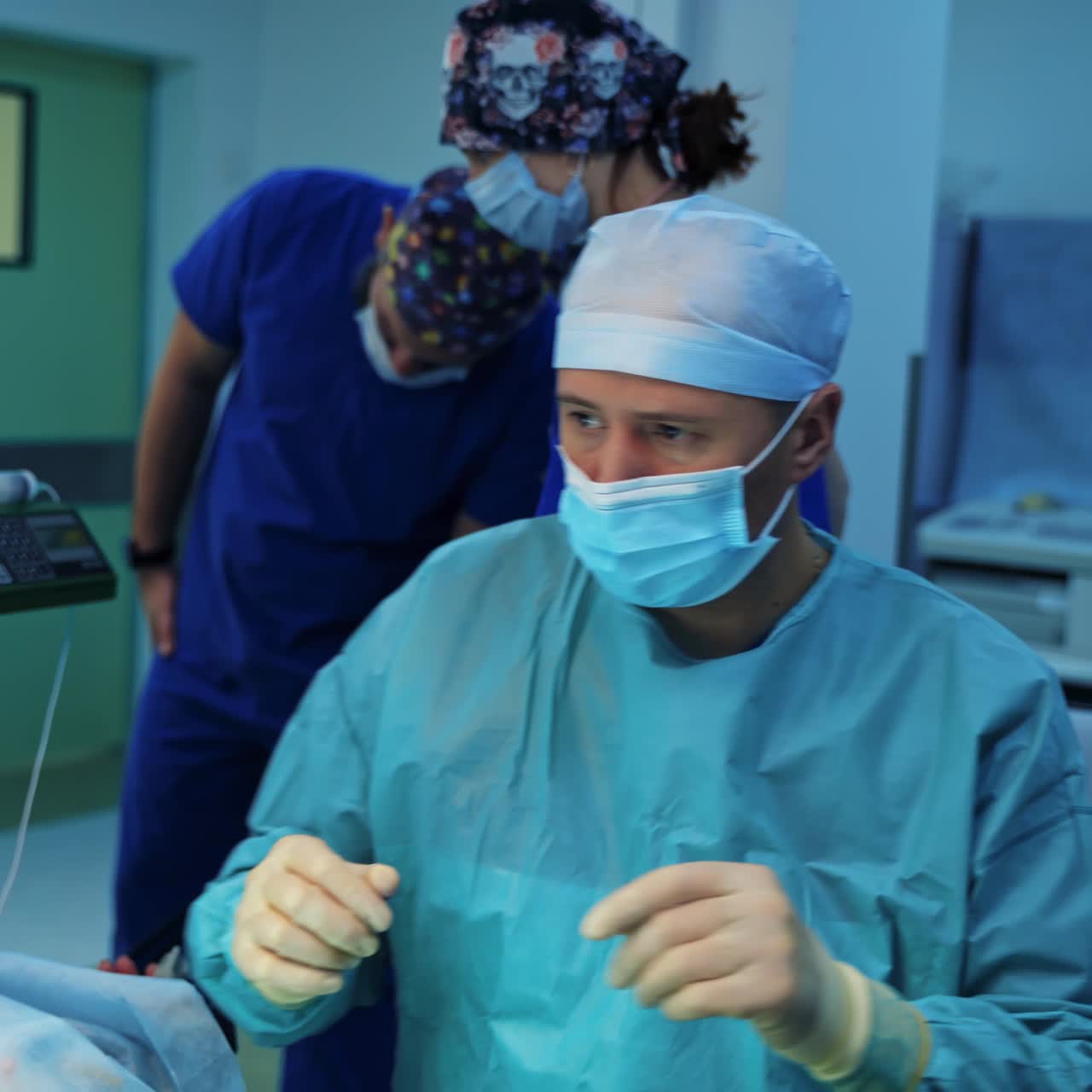 Male specialist doing plastic surgery. Surgeon performs blepharoplasty on modern medical equipment background. Doctor operates in operating room.