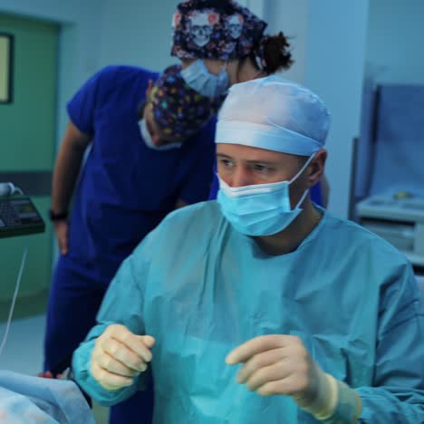 male specialist doing plastic surgery. surgeon performs blepharoplasty on modern medical equipment background. doctor operates in operating room.