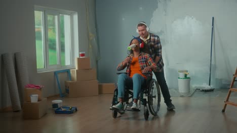 a white man wheeling an african american woman in.mov | adult, african, american, apartment