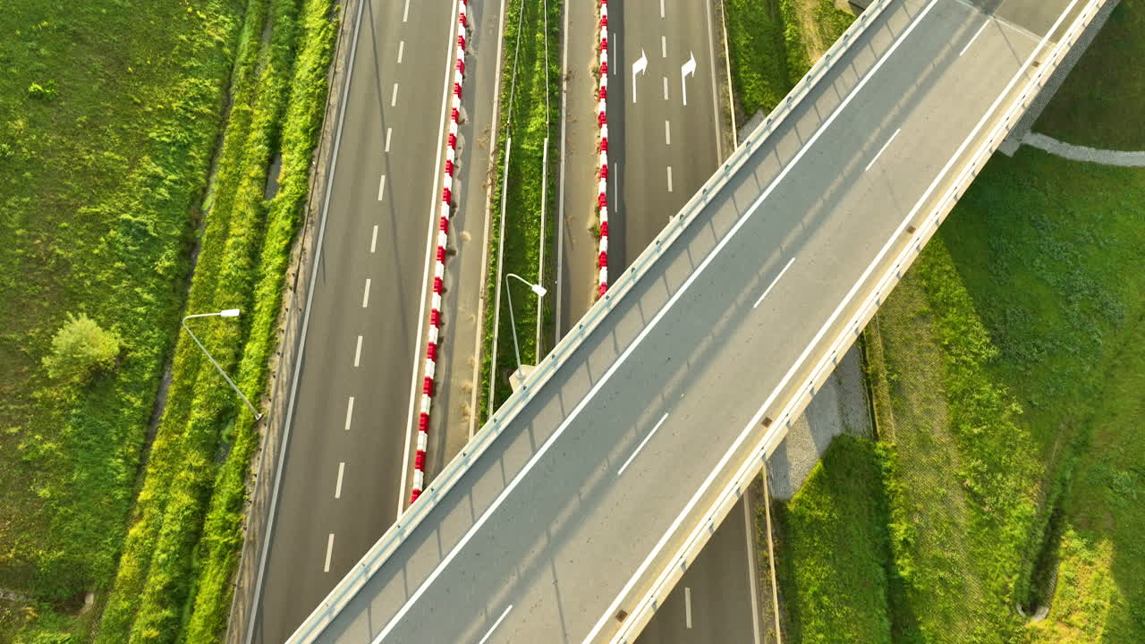 Top down view of car driving under overpass on modern multilane highway