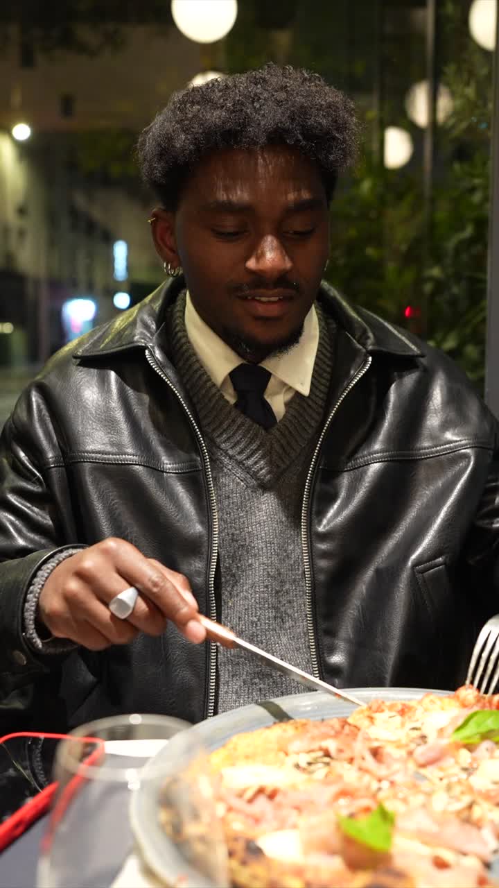 Man eating pizza at a restaurant
