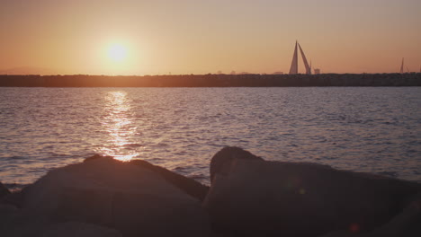 sailboats return home through a pacific channel