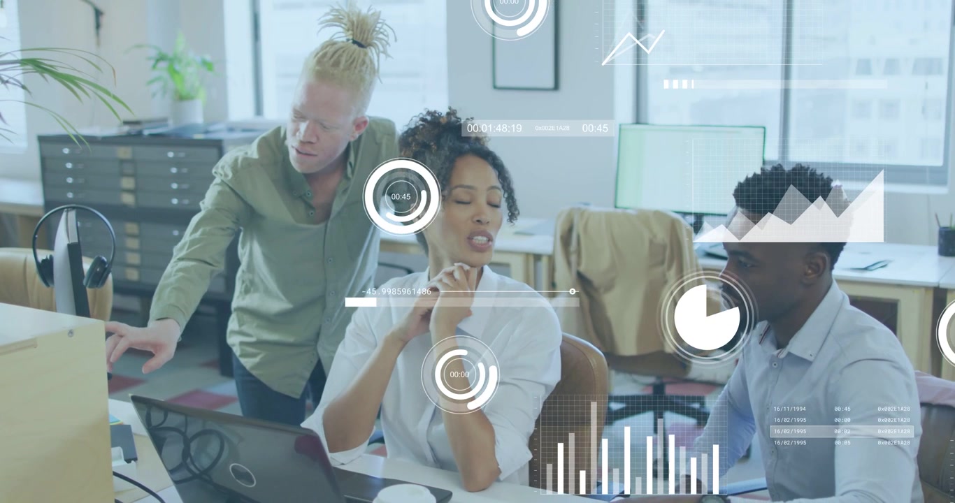 Standing man pointing at monitor initiating HUD charts while seated team discussing business data