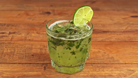 close-up of a mojito cocktail on a wooden table in a restaurant