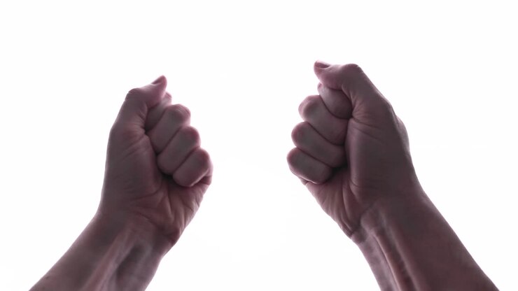 Close Up Of Man's Hands Clench Into Fists, Isolated In White Background - studio shot