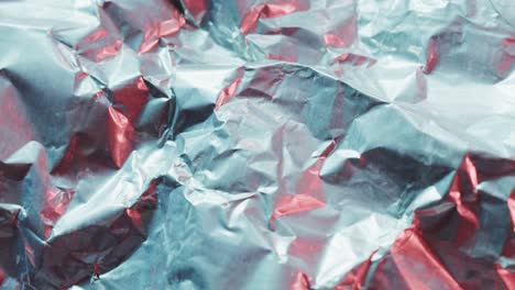 close up of gray crumpled pieces of plastic material in slow motion