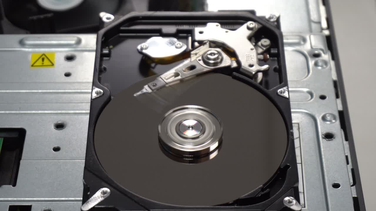 4K Close up of a hard disk drive reading and writing data and internal structure for computer PC or Server and Cloud technology.