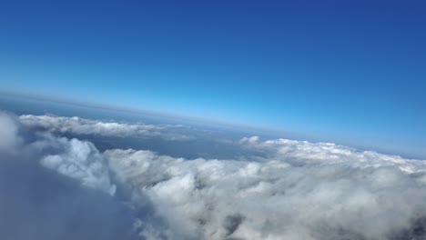 an immersive view through the pilot’s eyes while flying in a left turn near cottony storm cloud tops, with a horizon under. a deep blue sky. hyper-realistic 4k