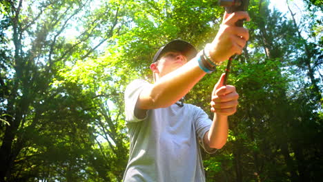 youth swinging a fishing rod and releasing the line