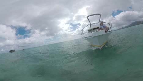 man having water trip in the ocean yacht sailing by crystal rock near mauritius