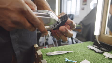 barber attaching comb to trimmer