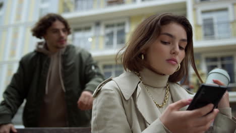 woman waiting boyfriend outdoor. man closing girlfriend eyes on city street.