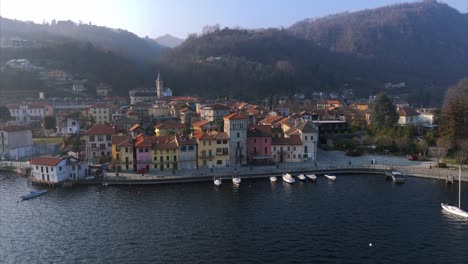 lakeside village of pella on lake orta, italy. aerial drone backward ascending, copy space
