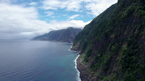 massive steep rock cliffs of madeira coastline above atlantic ocean