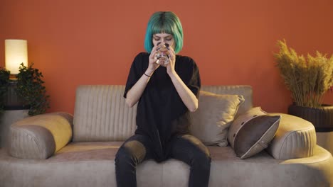 cowardly young woman drinks water with trembling hand.