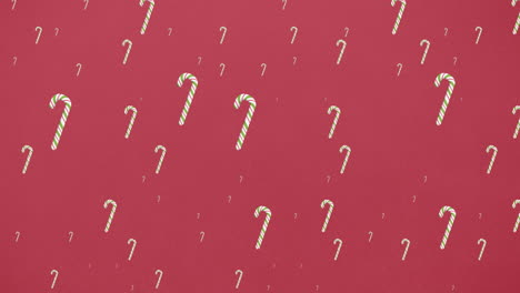 animación de dulces de navidad cayendo sobre un fondo rojo