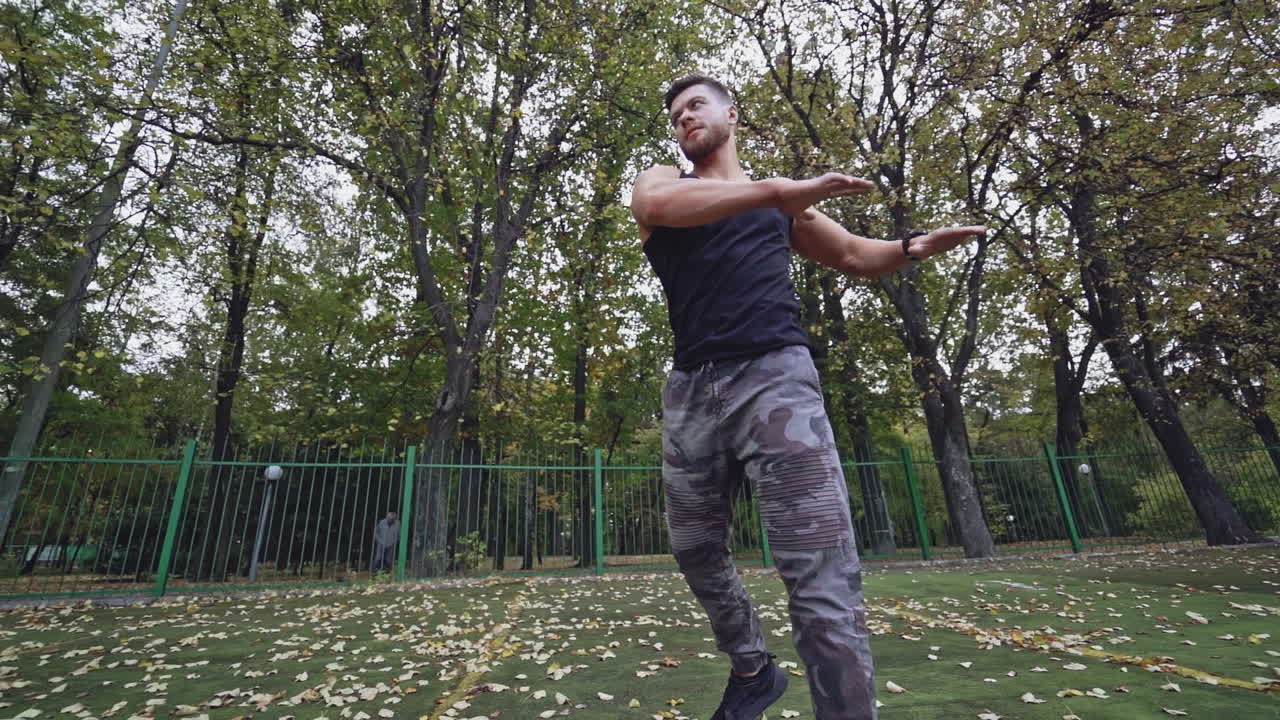 Young man exercise outdoors. Athletic man training at the stadium