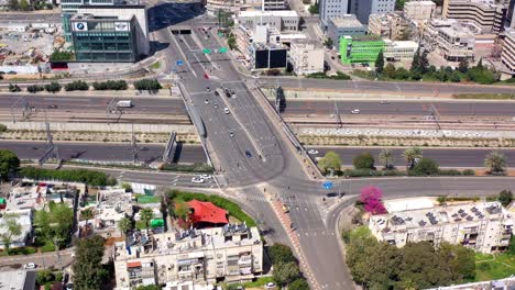 aerial view of a multi-level urban intersection with highways and railway tracks
