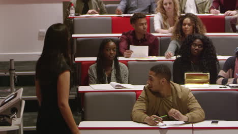 female teacher talking with students in a lecture theatre, shot on r3d