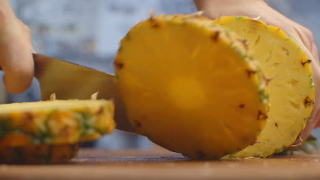 Pineapple-close-up-cut-on-a-wooden-board.-shred.