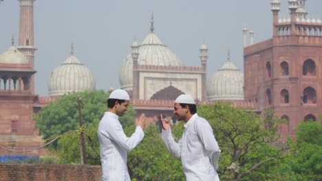 young muslim men doing adab to each other as greeting at a mosque