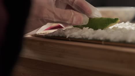 chef preparing sushi rolls in the kitchen