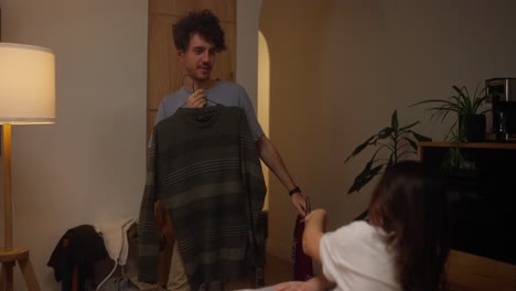 couple choosing clothes at home at night