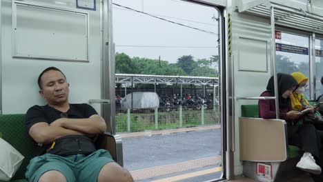 passengers inside a train carriage at a station