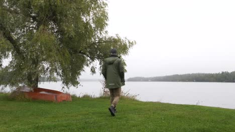 rear view of man contemplating at foggy autumn lake, hikikomori concept