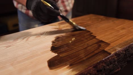 applying wood stain to a table top